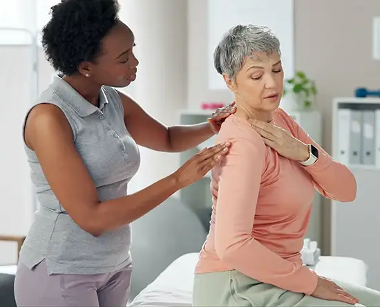 doctor examining patient with an injured arm at premier injury care